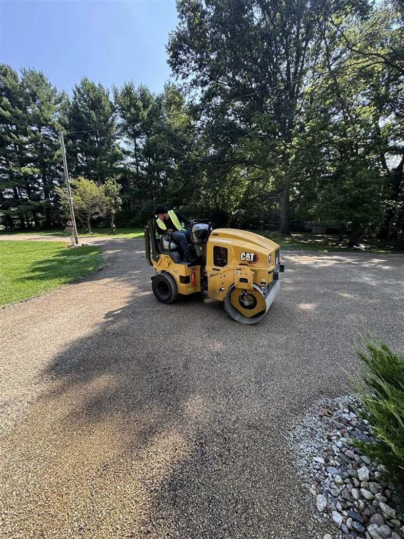 CAT roller compacting a chip seal surface