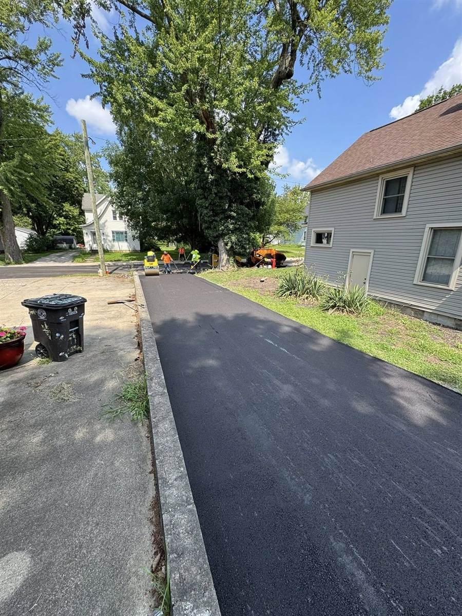 Clean, freshly paved driveway between two homes