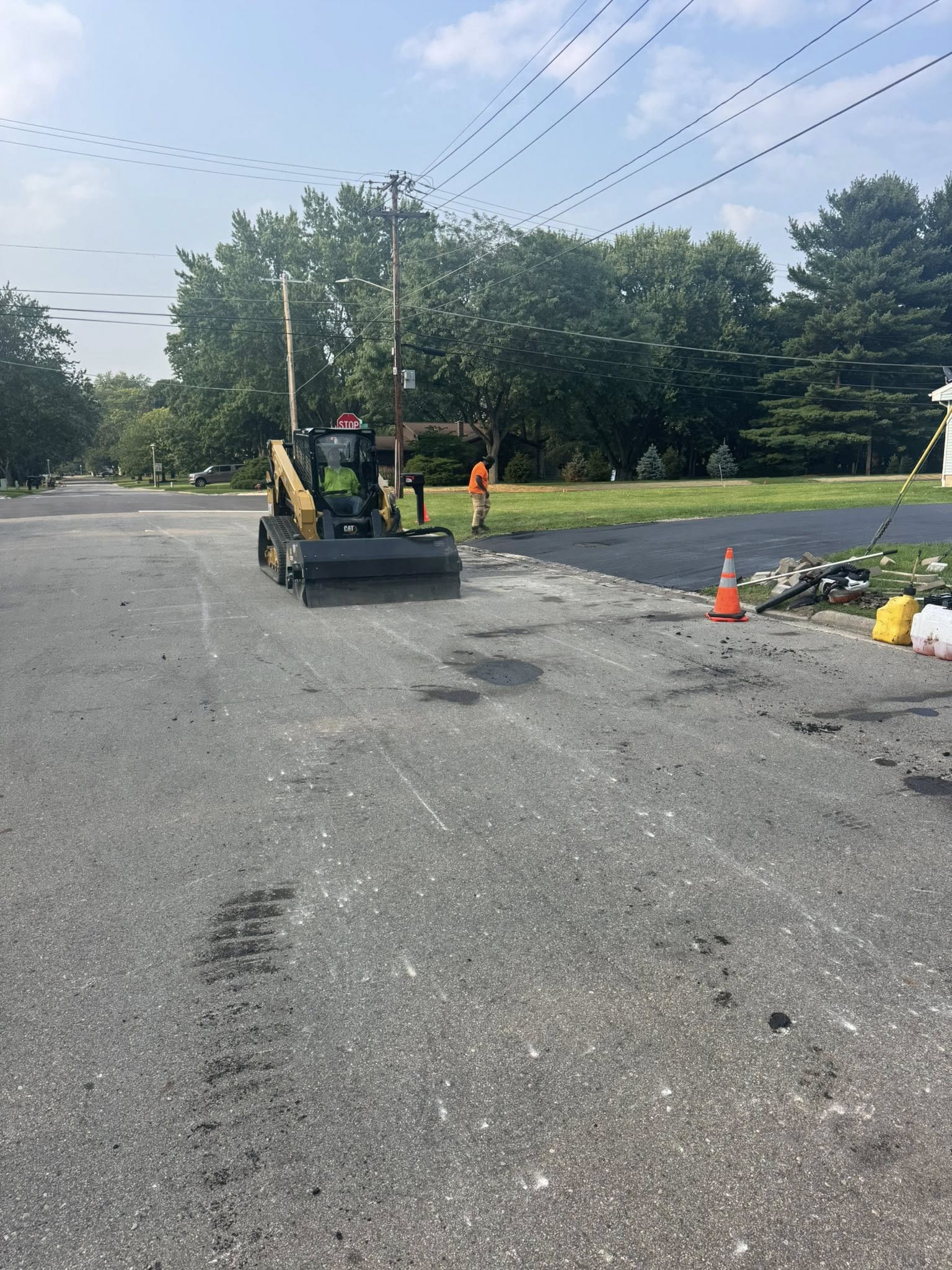 Asphalt repair crew patching a damaged parking lot