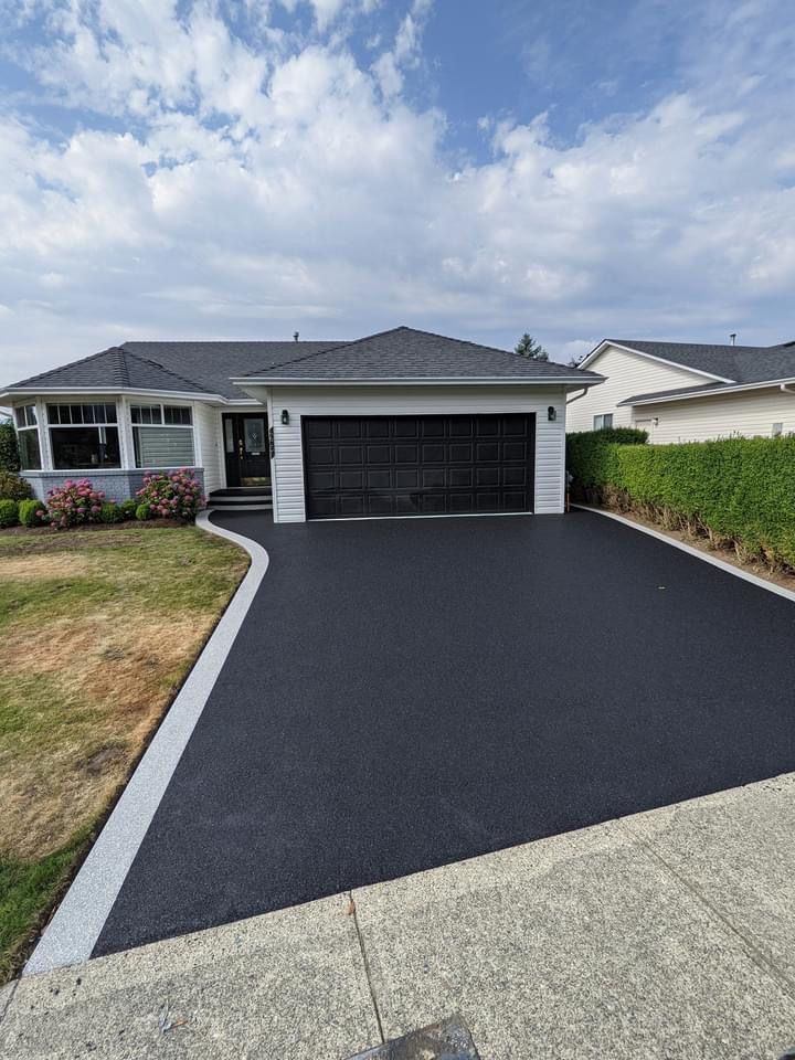 Finished asphalt driveway in front of a residential garage
