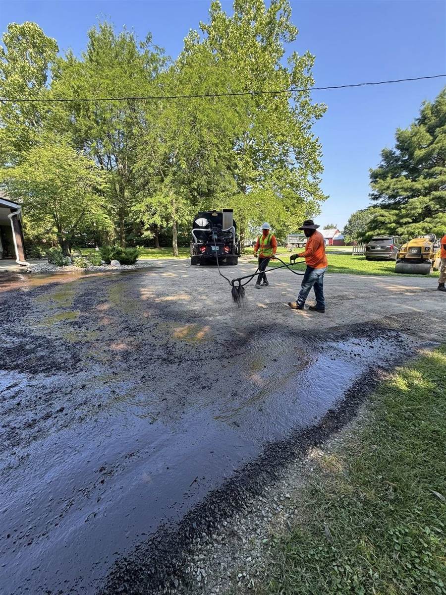 Fresh sealcoat applied to an asphalt driveway